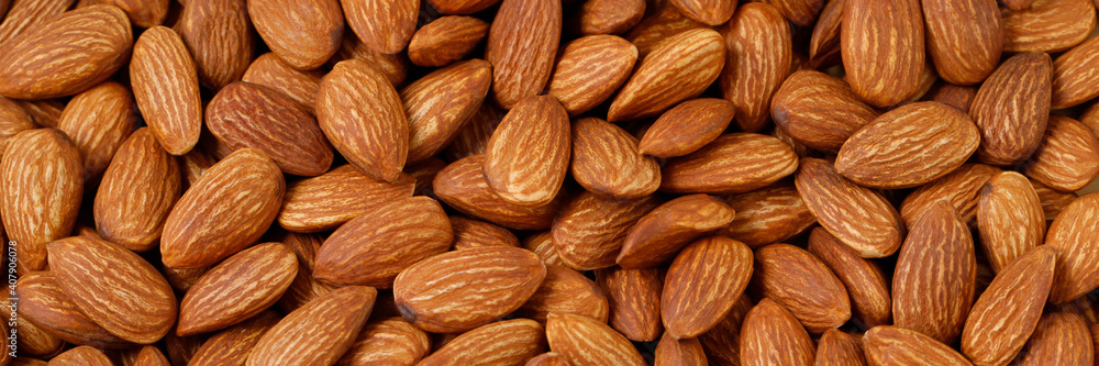 Organic almond nut raw peeled as background, top view. Healthy snack or for vegetarians. copy space banner. Organic almond nut raw peeled as background, top view. Healthy snack or for vegetarians. copy space banner.