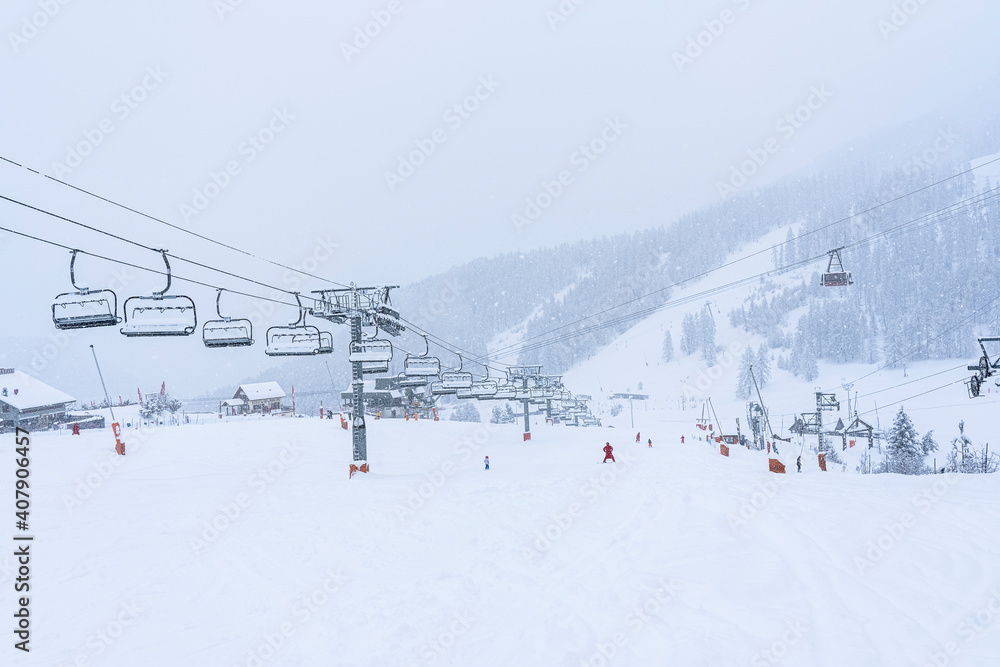 Auron, FRANCE - 01.01.2021: Empty ski slopes and ski lifts in ski resort. During the winter holidays 2021 January lifts are closed for skiing for adults due to the coronavirus pandemic. Auron, FRANCE - 01.01.2021: Empty ski slopes and ski lifts in ski resort. During the winter holidays 2021 January lifts are closed for skiing for adults due to the coronavirus pandemic.