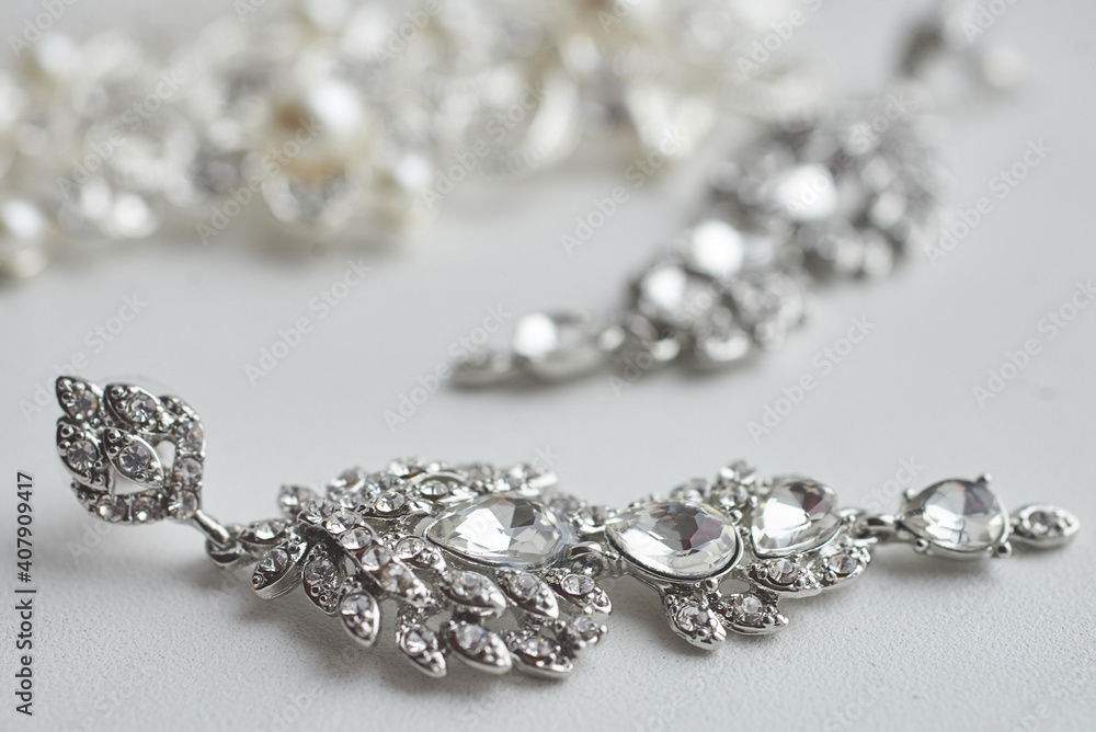 luxury earrings made of crystals and rhinestones on a white background. wedding accessories luxury earrings made of crystals and rhinestones on a white background. wedding accessories