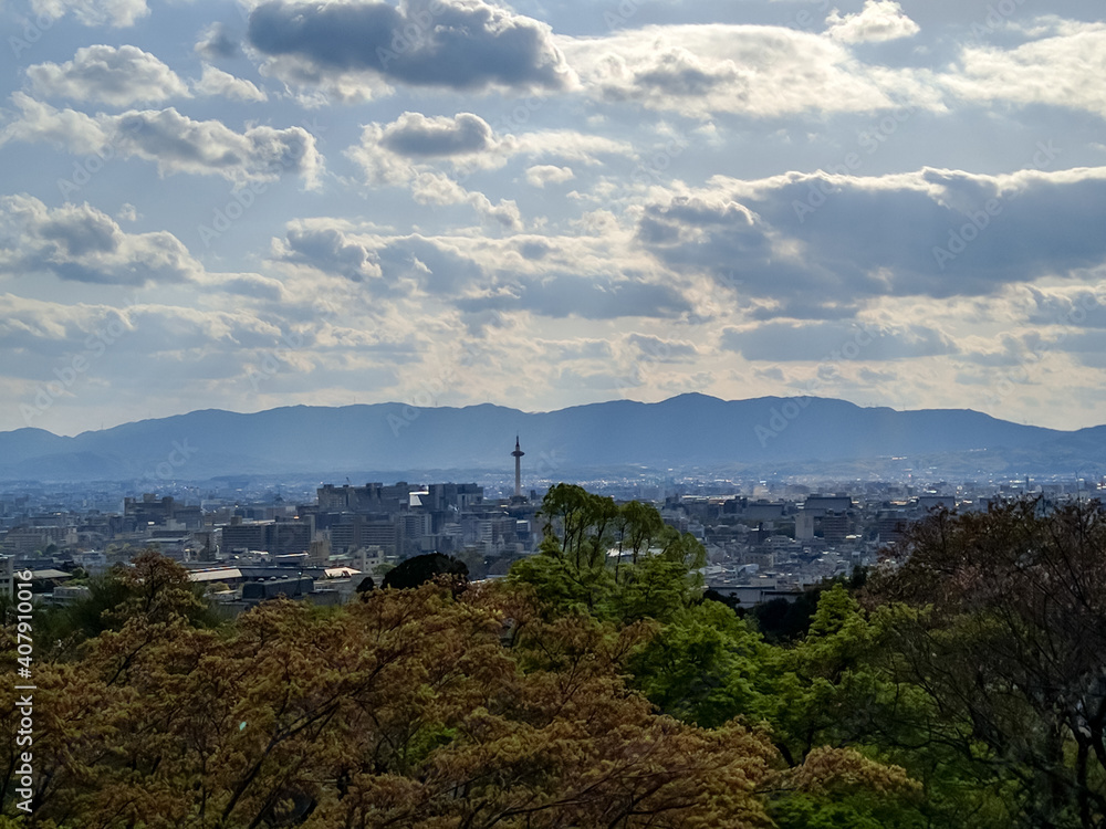 KYOTO, JAPAN - APRIL 5, 2018: View of the city of Kyoto from the territory of the Kiyomizudera temple - Temple of Pure Water. The dense buildings of the city and mountains are visible.