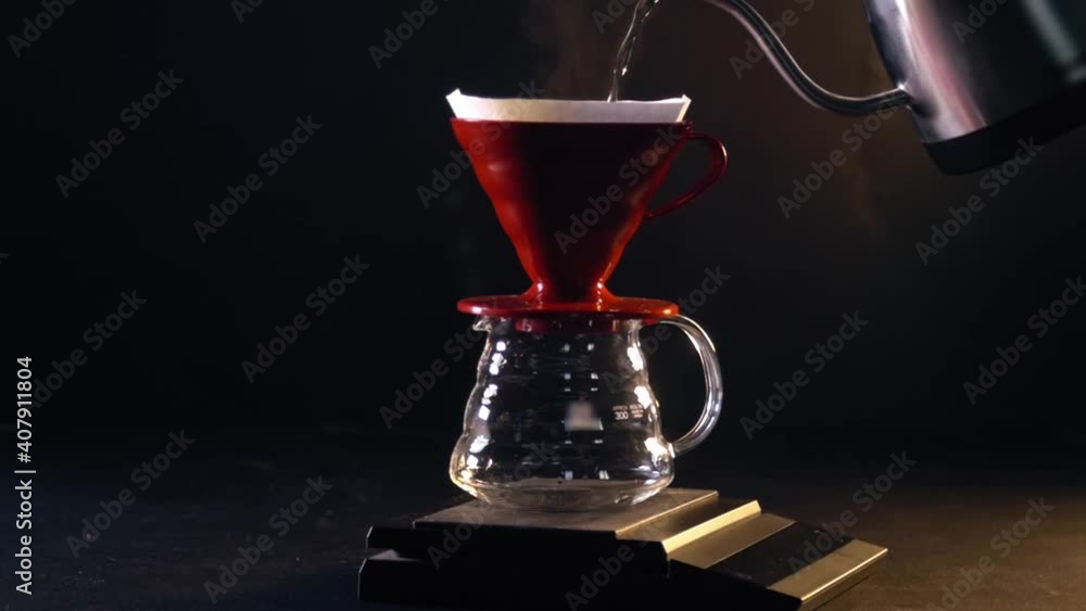 Coffee brewing on black background - pour over Coffee brewing on black background - pour over