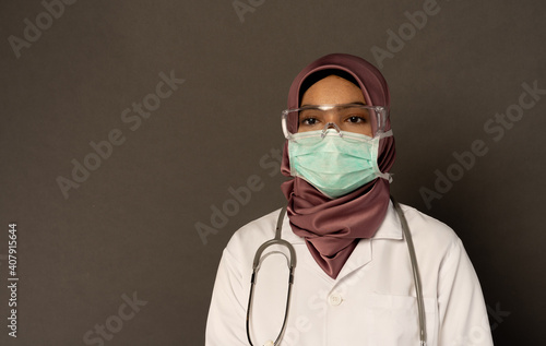 Researcher wearing protection with grey background.