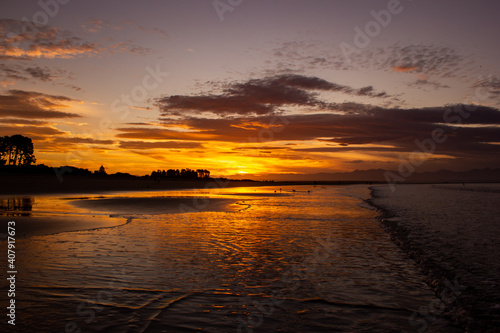 beach in nelson during a breathtaking sunset on Tahunanui Beach at Nelson  New Zealand