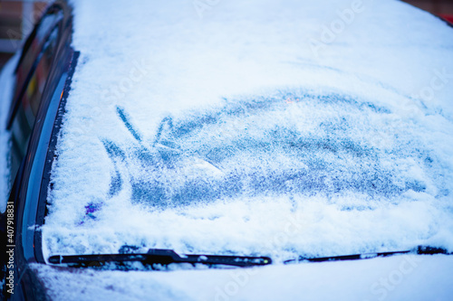 snowy car windshield outdoors in city in winter