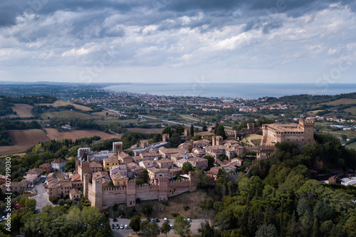 Italy - aerial view of the medieval village of Gradara in the province of Pesaro and Urbino in the Marche region. In the background the Romagna Riviera and the Adriatic Sea © cristian