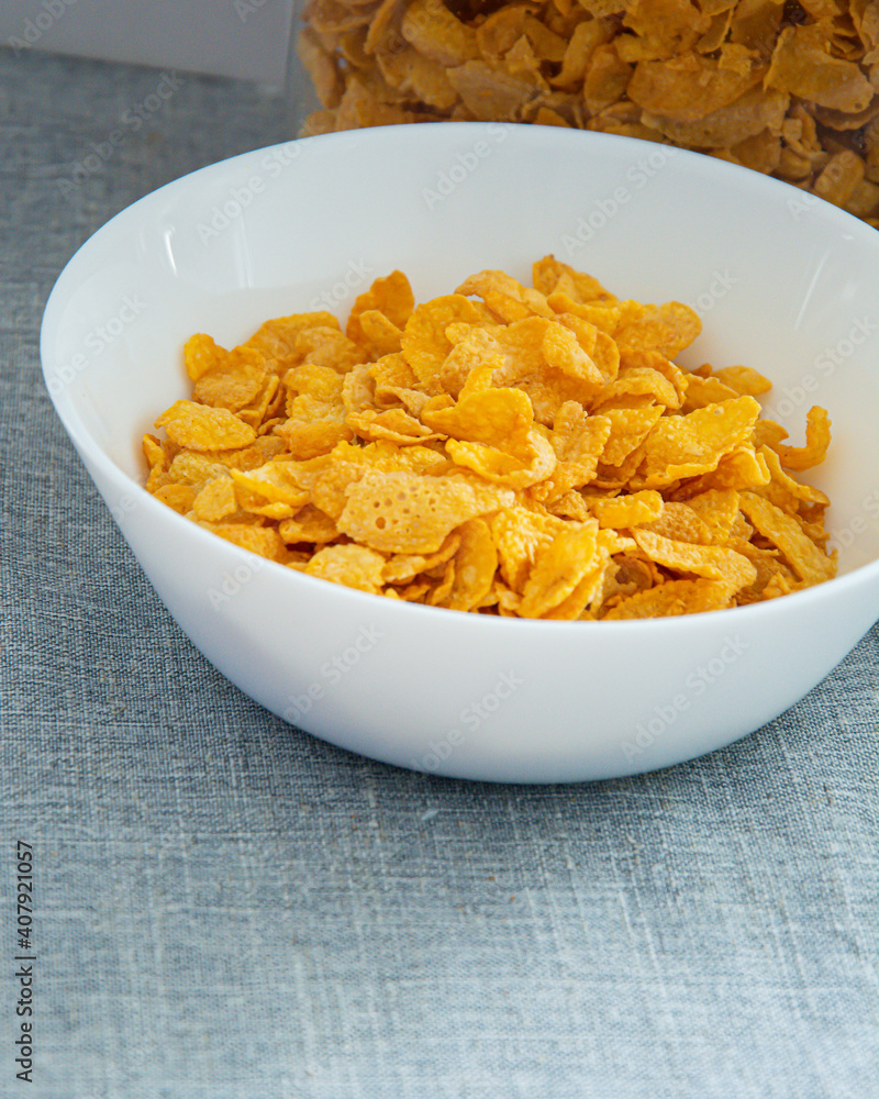 Bowl of cornflake in white container ,Signifying healthy breakfast Bowl of cornflake in white container ,Signifying healthy breakfast