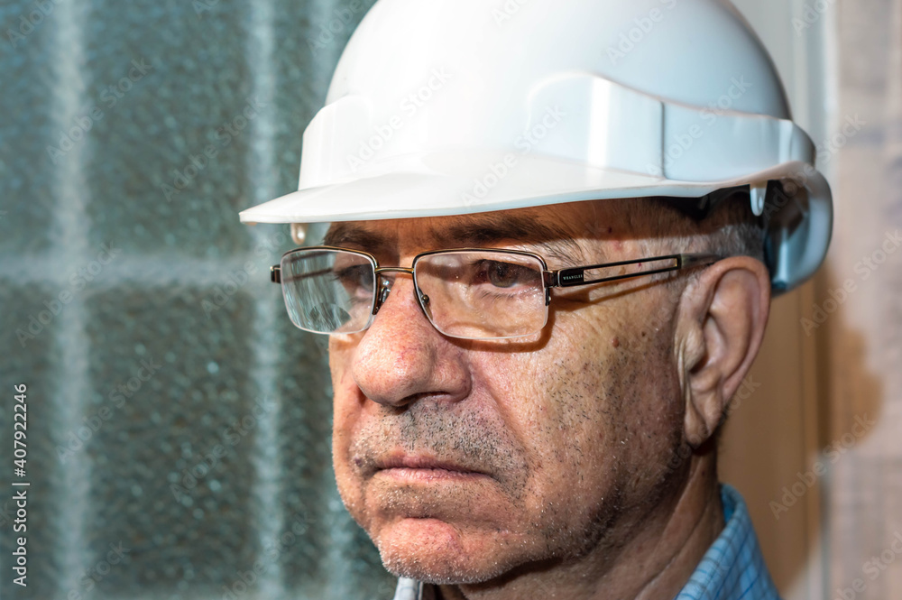 Portrait of man with glasses and white engineer helmet Portrait of man with glasses and white engineer helmet