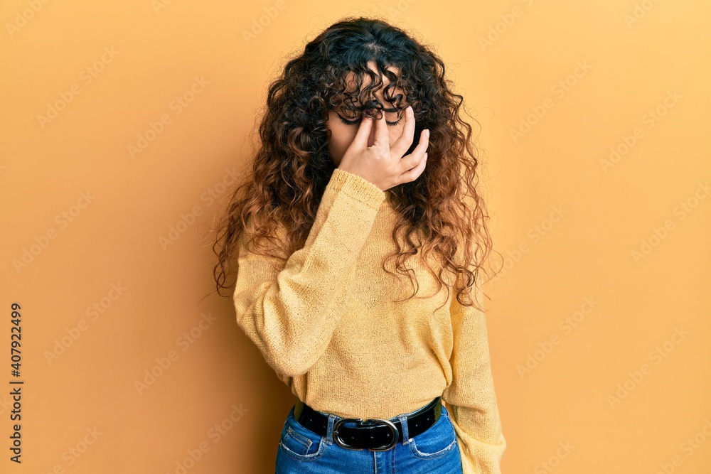 Young hispanic girl wearing casual clothes tired rubbing nose and eyes feeling fatigue and headache. stress and frustration concept. Young hispanic girl wearing casual clothes tired rubbing nose and eyes feeling fatigue and headache. stress and frustration concept.