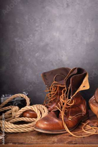 old leather travel vintage boots shoes and bag at table