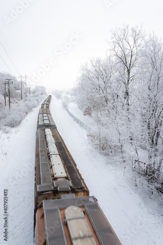 train passing through fresh snow fall on the tracks