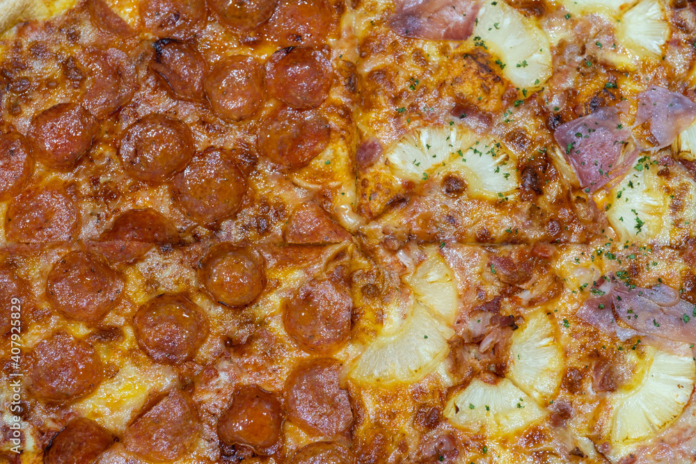 Top view of pizza background with sliced pepperoni , Pineapples , Parma ham. Pizza background half pepperoni and hawaiian.