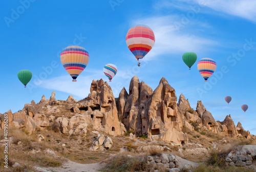 Colorful hot air balloons flying in blue sky over Cappadocia, Central Anatolia, Turkey. Goreme National Park