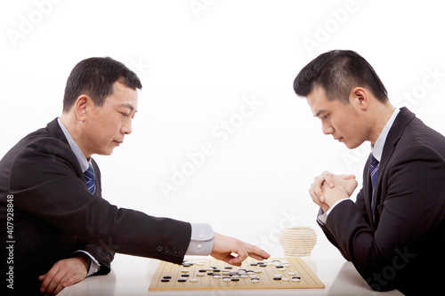 Two business men playing chess