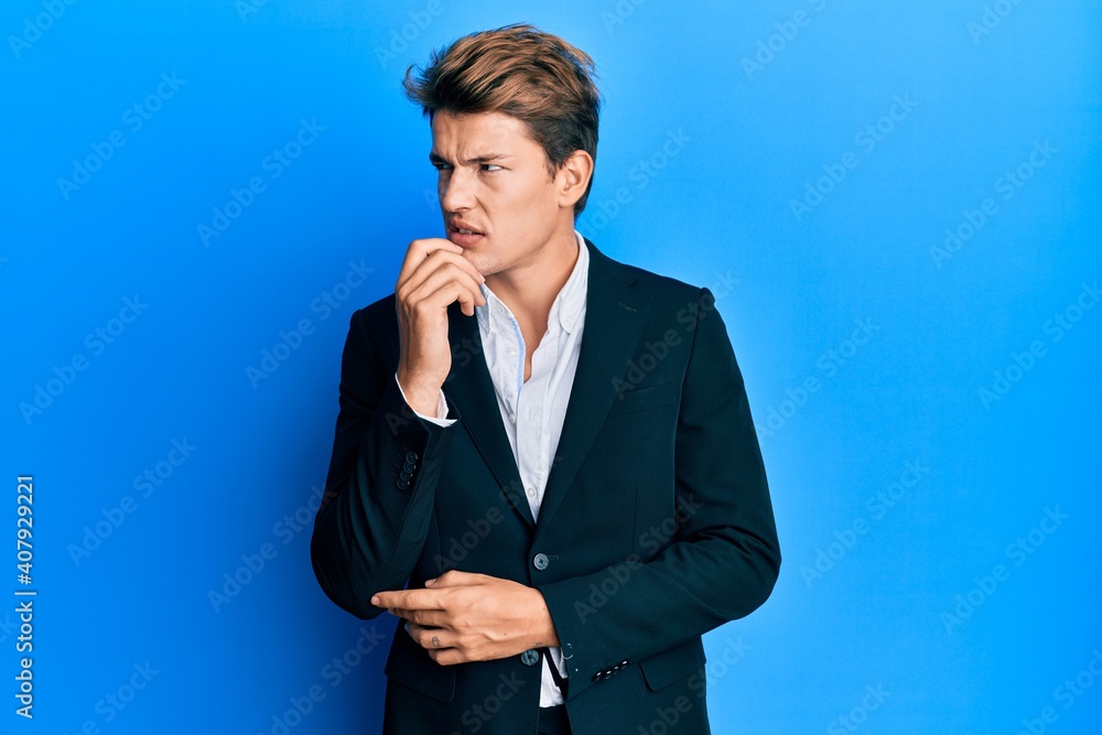 Handsome caucasian man wearing business suit and tie serious face thinking about question with hand on chin, thoughtful about confusing idea Handsome caucasian man wearing business suit and tie serious face thinking about question with hand on chin, thoughtful about confusing idea