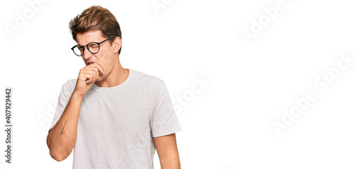 Handsome caucasian man wearing casual clothes and glasses feeling unwell and coughing as symptom for cold or bronchitis. health care concept.