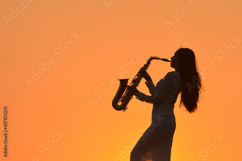 Canvas Print Saxophone, music instrument played by saxophonist player musician  in lake on du