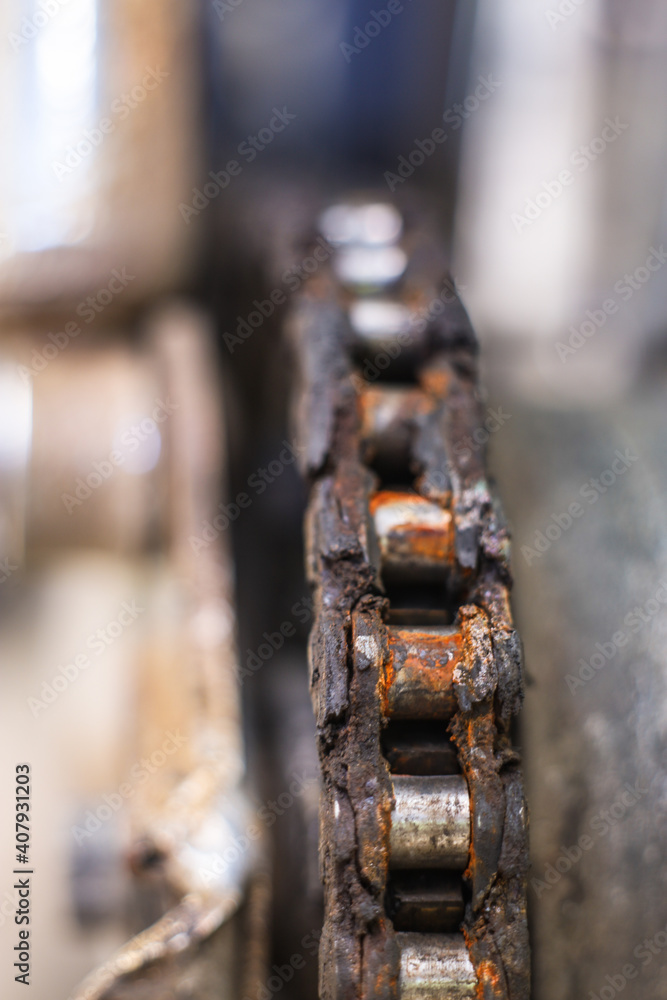 Mechanical device with gears and a chain inside. Part of the motorcycle engine close-up. Shine oil. Mechanical device with gears and a chain inside. Part of the motorcycle engine close-up. Shine oil.