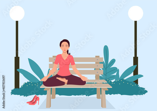 Woman doing yoga on a bench at the park