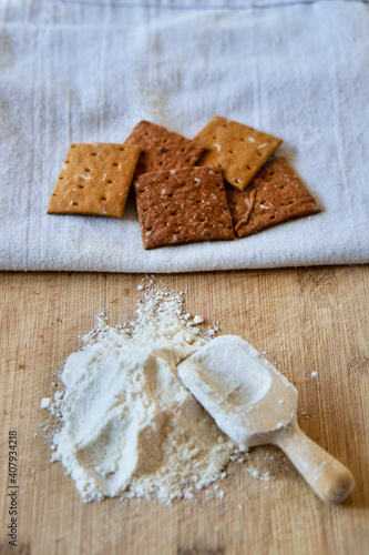 Cricket insect crackers snack and cricket flour for eating as food items made of cooked insects as a good source of protein. Entomophagy concept. The concept of protein food sources from insects.