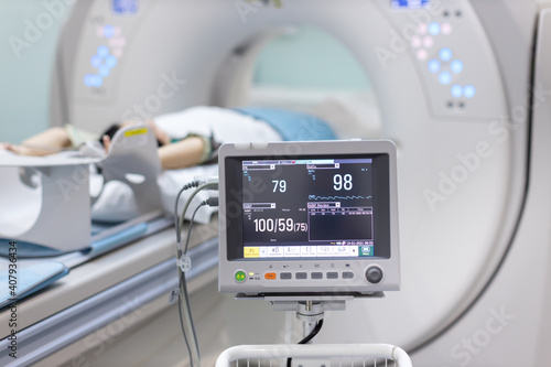 Electrocardiogram in hospital CT Scan room. heart rate monitor in hospital. Process of CT scanning of an old patient. Man Receiving a Medical Scan for a Trauma