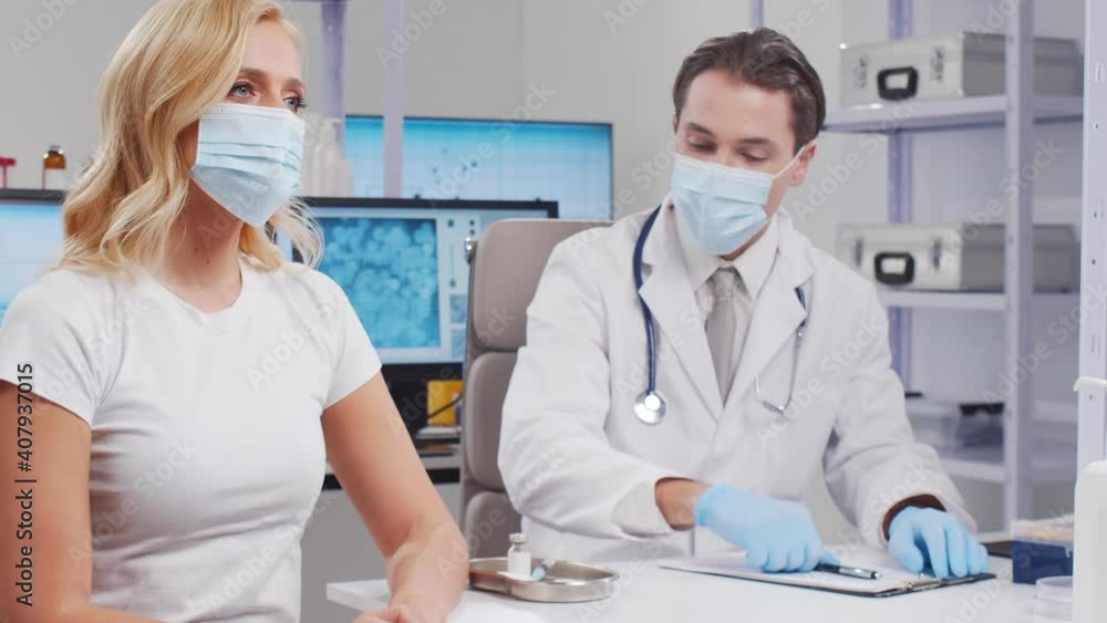 Doctor makes a coronavirus vaccine using a syringe and hypodermic needle. Professional medical worker and patient at the hospital office. Vaccination and safety concept. Doctor makes a coronavirus vaccine using a syringe and hypodermic needle. Professional medical worker and patient at the hospital office. Vaccination and safety concept.