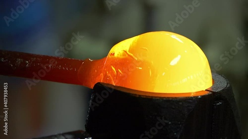 Glass handmade production, golden ball of hot glass.