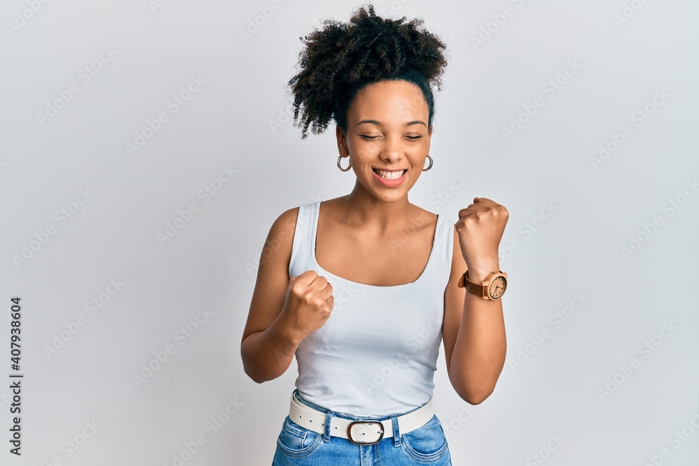 Young african american girl wearing casual style with sleeveless shirt celebrating surprised and amazed for success with arms raised and eyes closed