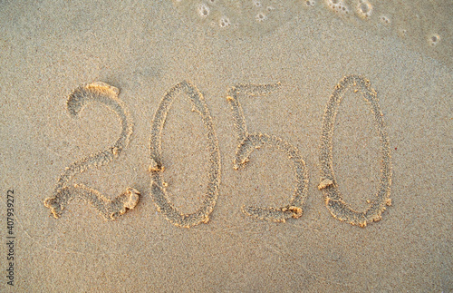 New year, number 2050 on beach sand. Holiday concept. 2050 plan