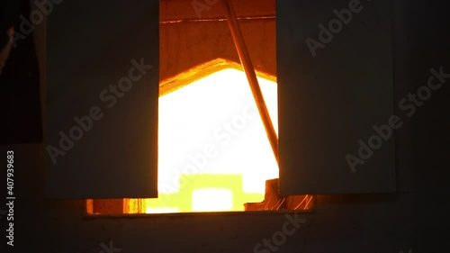Glass handmade production, golden ball of hot glass.