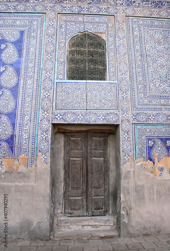 Khiva, Uzbekistan - December 02 2019: Ancient wall and door with ornament. Interior decoration of the Tosh-Hovli palace