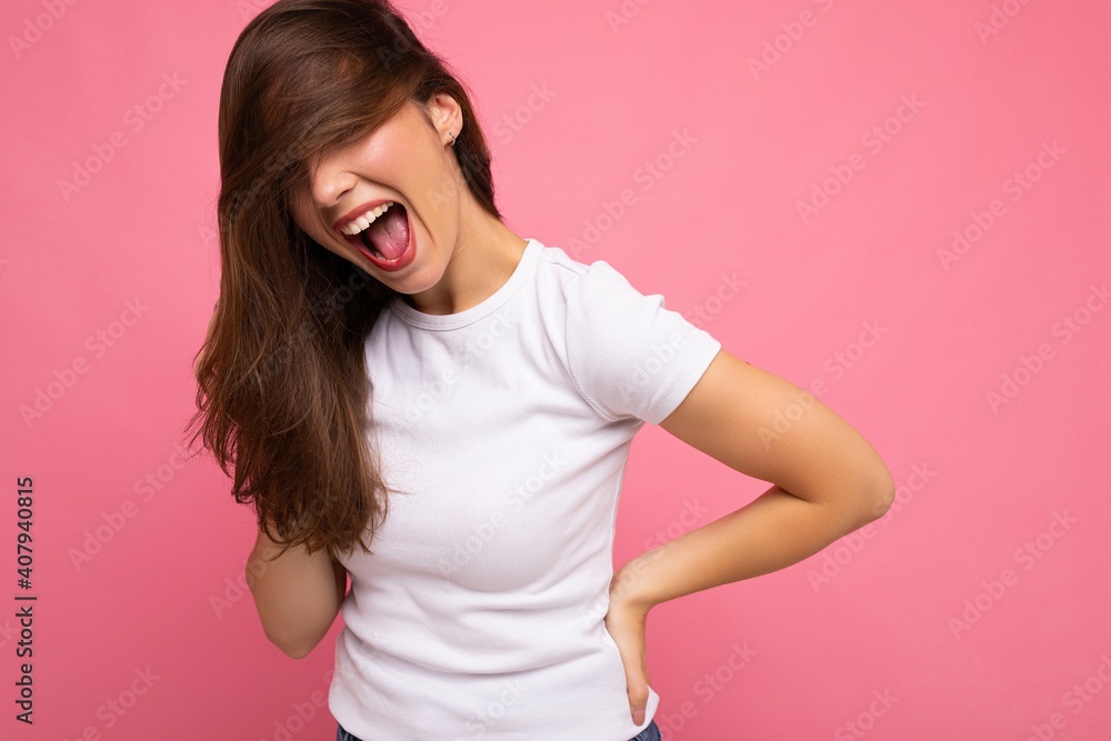 Portrait of positive cheerful fashionable woman in casual white t-shirt for mock up isolated on pink background with copy space Portrait of positive cheerful fashionable woman in casual white t-shirt for mock up isolated on pink background with copy space