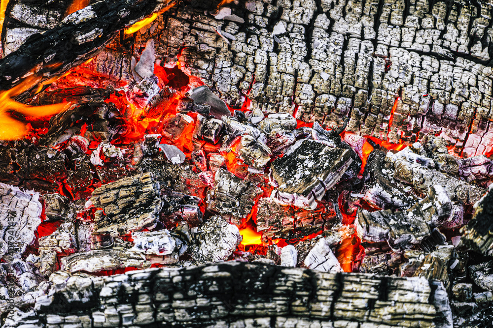 Brightly glowing red-hot charcoal. Firewood burnt to ashes. Brightly glowing red-hot charcoal. Firewood burnt to ashes.