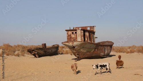 Moynaq (Mo‘ynoq or Muynak), Uzbekistan - Desember 06 2019:  an abandoned rusty ship in the Aral sea. Ecological disaster. Dry bottom of the Aral Sea. World famous as the largest man made disaster. 