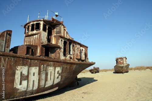 Moynaq (Mo‘ynoq or Muynak), Uzbekistan - Desember 06 2019:  an abandoned rusty ship in the Aral sea. Ecological disaster. Dry bottom of the Aral Sea. World famous as the largest man made disaster. 