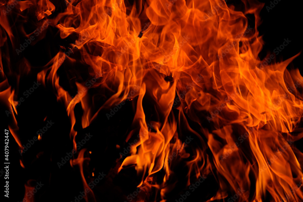 Red bonfire in the dark. Fire twigs at night close-up. Red bonfire in the dark. Fire twigs at night close-up.