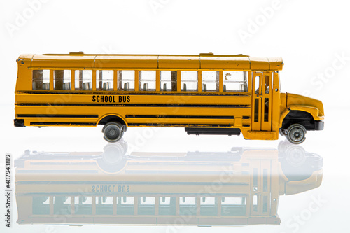 Broken toy car on white background with reflection