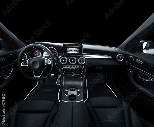 Luxury car interior. Steering wheel, shift lever and dashboard. black leather interior with black dashboard. on an isolated black background
