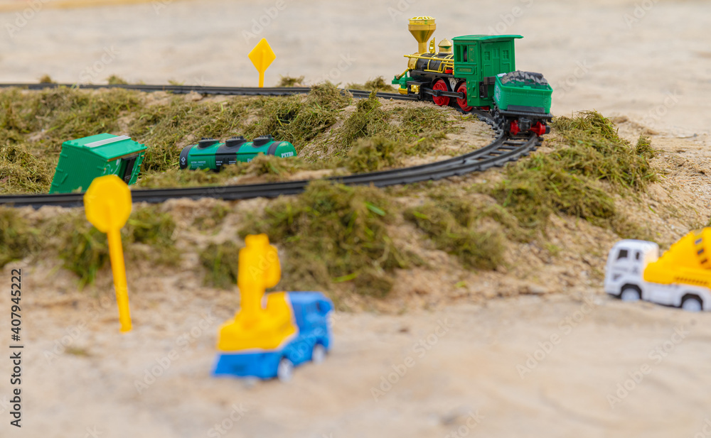 Toy Model railway on the Ground surrounded by grass