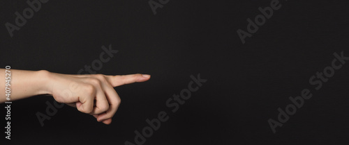 Index finger pointing to something, isolated on black background.