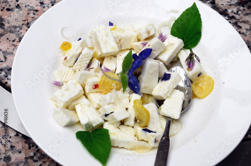 Cheese salad with gentian sage and chives flowers and lemon - Schafskaesesalat