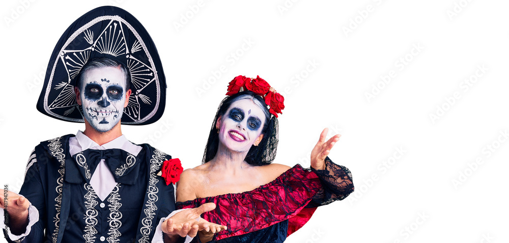 Young couple wearing mexican day of the dead costume over background smiling cheerful offering hands giving assistance and acceptance. Young couple wearing mexican day of the dead costume over background smiling cheerful offering hands giving assistance and acceptance.