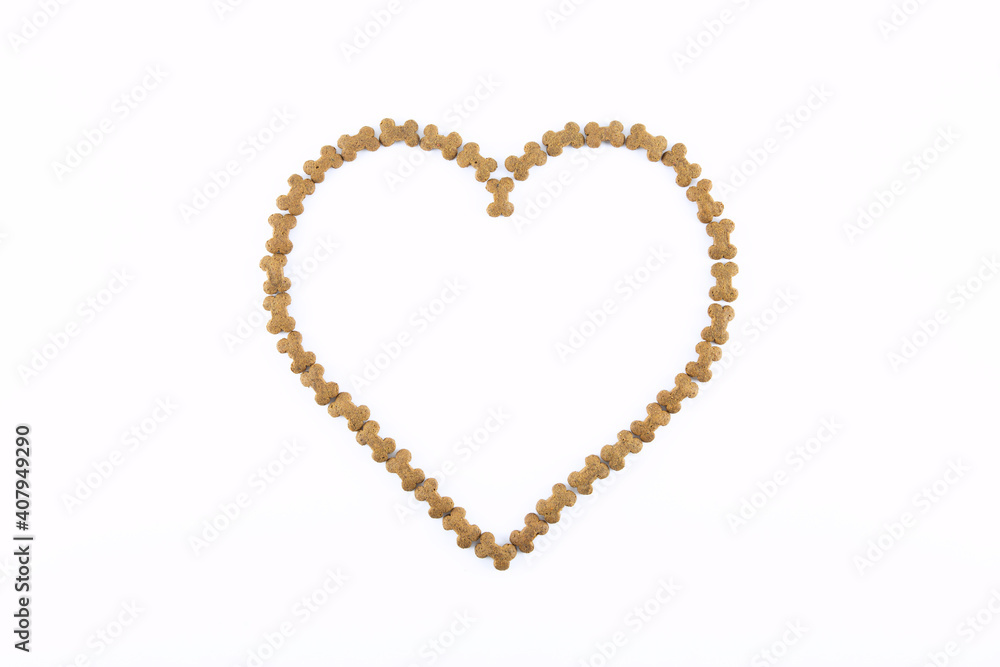 Dried animal pet dog food in heart form isolated on white background . Dog love dry food Biscuits