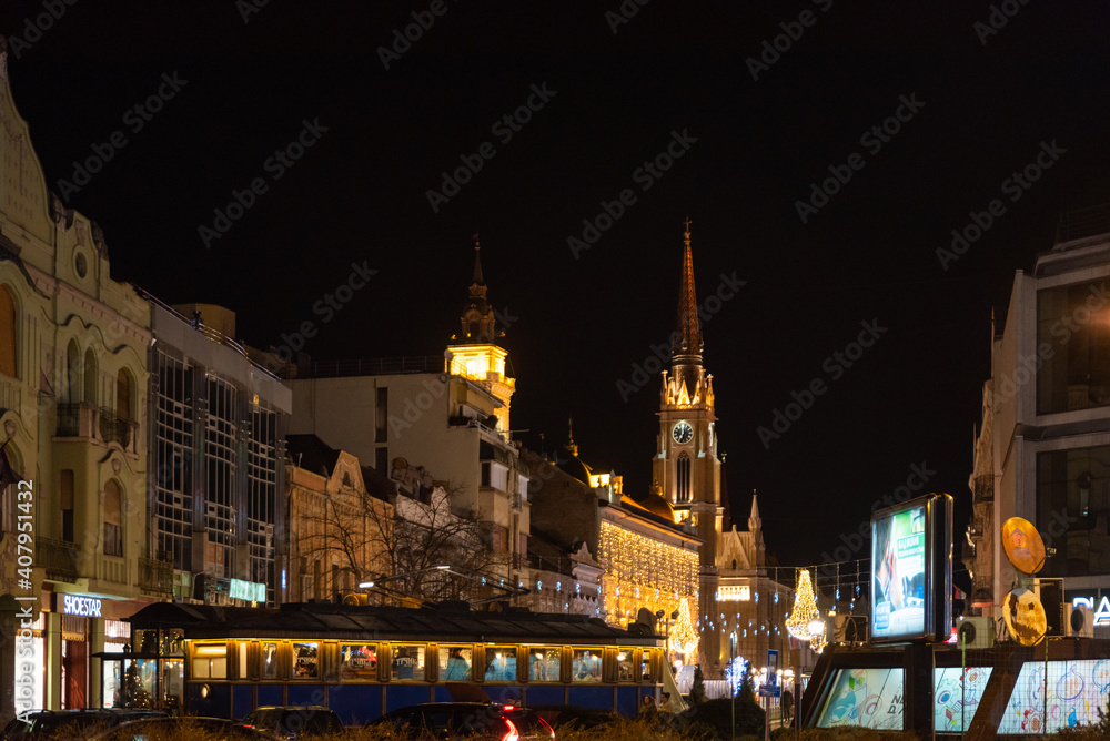 Night images of city of Novi Sad with building architecture and night life with people selective focus with film grain.