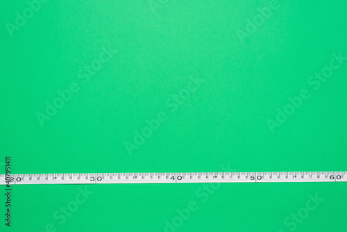 Garden tape on the green flat lay background with copy space.