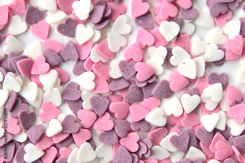 Delicious pink Valentine's Day sugar hearts and ornaments in pink, purple and white show I love you to your girlfriend and beloved people with precious diamonds and red hearts jewelry as special gift