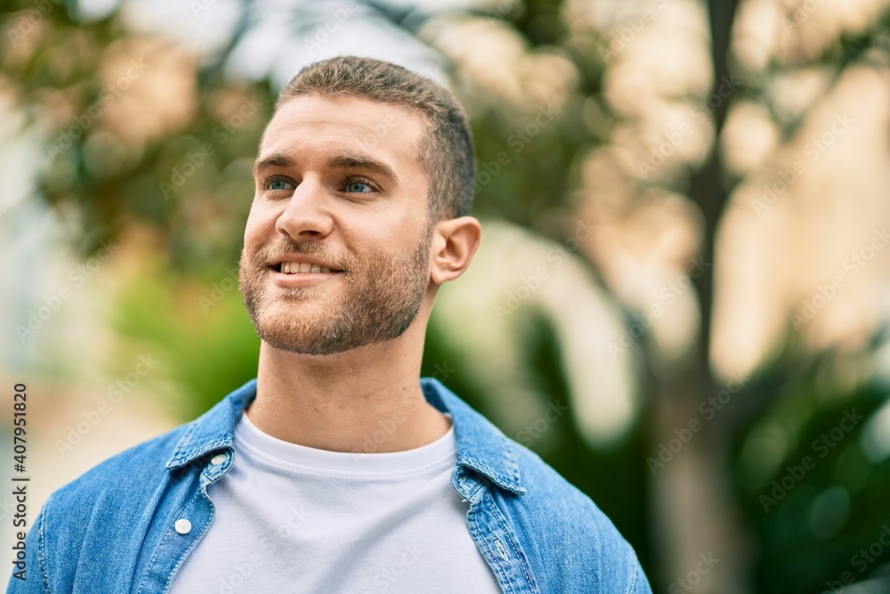 Young caucasian man smiling happy standing at the park. Young caucasian man smiling happy standing at the park.
