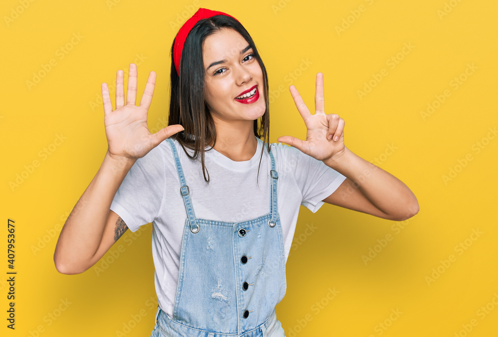 Young hispanic girl wearing casual clothes showing and pointing up with fingers number eight while smiling confident and happy. Young hispanic girl wearing casual clothes showing and pointing up with fingers number eight while smiling confident and happy.
