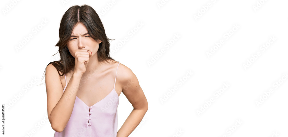 Young beautiful caucasian girl wearing casual clothes feeling unwell and coughing as symptom for cold or bronchitis. health care concept. Young beautiful caucasian girl wearing casual clothes feeling unwell and coughing as symptom for cold or bronchitis. health care concept.