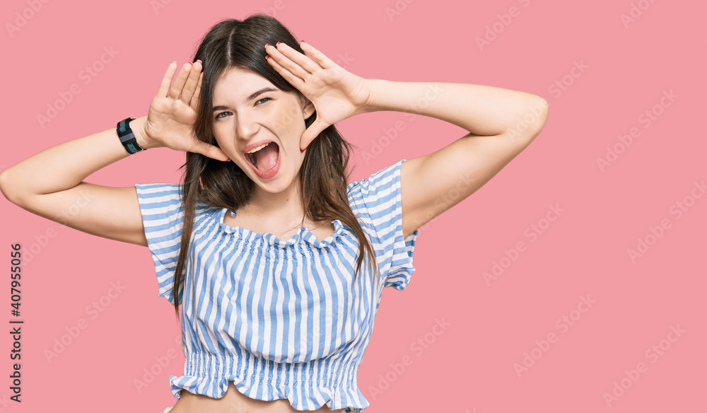 © Krakenimages.com - Young beautiful caucasian girl wearing casual clothes smiling cheerful playing peek a boo with hands showing face. surprised and exited