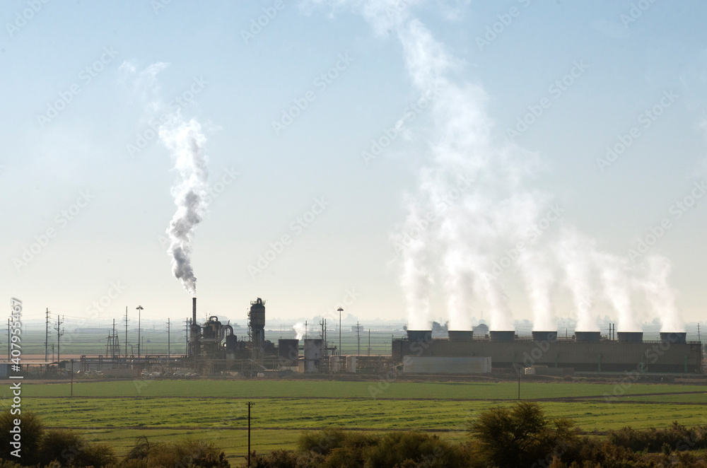 Smoke and emissions from many chimneys in a geothermal power station near Salton Sea, California Smoke and emissions from many chimneys in a geothermal power station near Salton Sea, California
